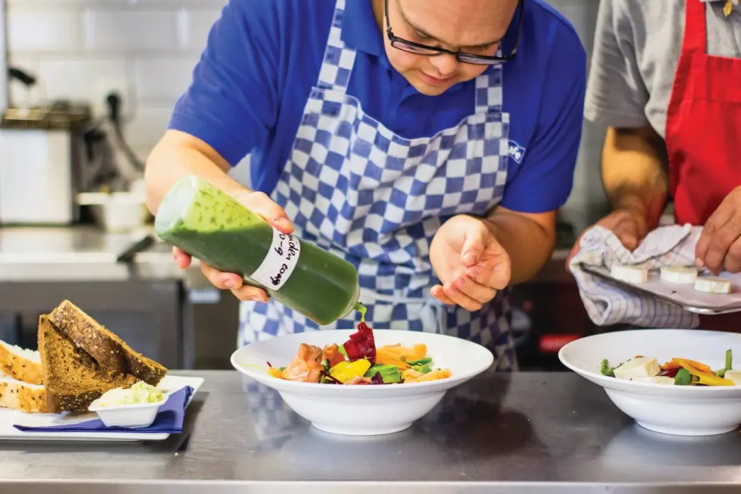 managing dysphagia in schools. Man pouring a sauce on a dish